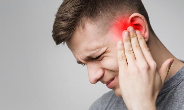 Man holding his ear