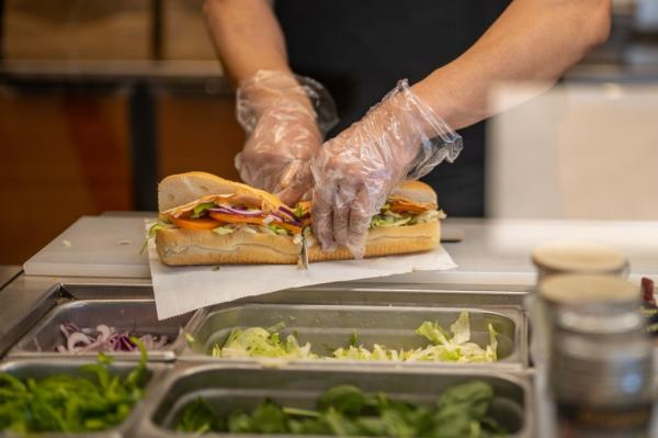  An employee halves a Subway sandwich at a Subway restaurant on January 12, 2023 in Austin, Texas. 