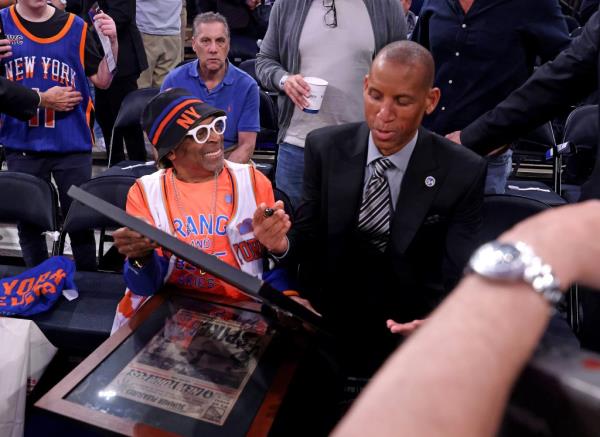 Indiana Pacers vs. New York Knicks at Madison Square garden - Indiana Pacers great Reggie Miller autographs two f<em></em>ramed newspapers for Spike Lee one of them is a New York Post before the start of to<em></em>nightas game.