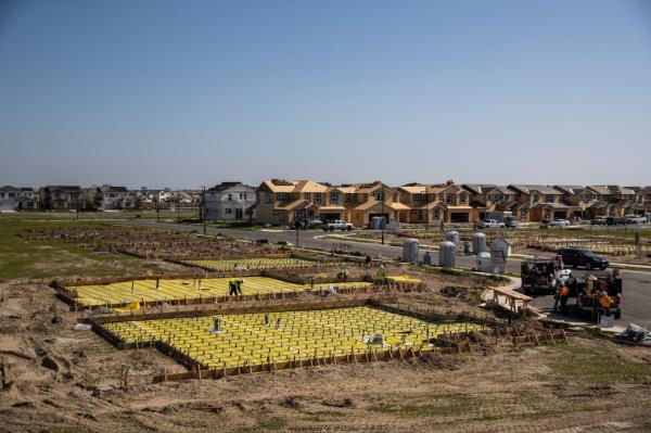 Workers build home foundations at the planned community at River Islands in Lathrop, California