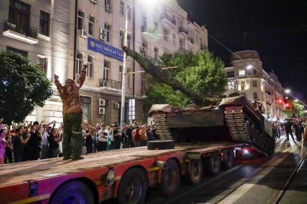 Members of the Wagner Group military company load their tank o<em></em>nto a truck on a street in Rostov-on-Don, Russia, Saturday, June 24, 2023