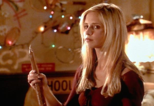 Sarah Michelle Gellar as Buffy holding a stake. 