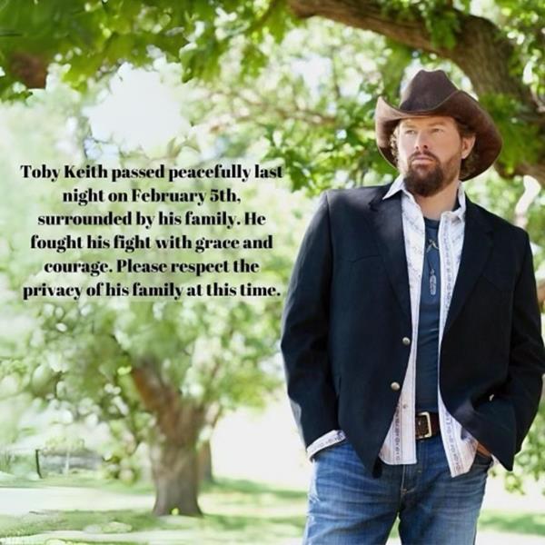 Toby Keith standing in front of a tree wearing a cowboy hat