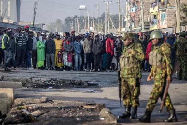 People gather in the Embakasi area of Nairobi a day after a gas explosion, on February 2, 2024. 