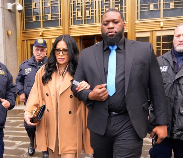 Jen Shah walking out of a court room with bodyguards. 