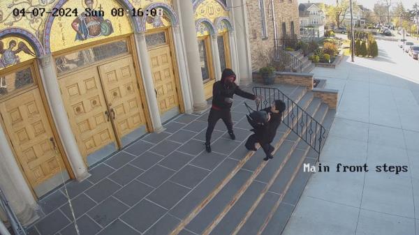 The video captures the moment the woman begins falling down the stairs.