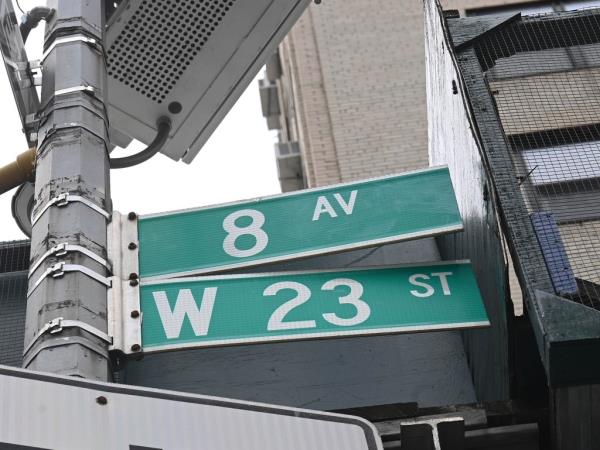 The sign marking Eighth Avenue and West 23rd Street.