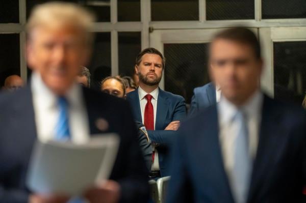 Sen. JD Vance (R-OH) looks on as former President Do<em></em>nald Trump speaks to the media during Trump's trial for allegedly covering up hush mo<em></em>ney payments at Manhattan Criminal Court on May 13, 2024.