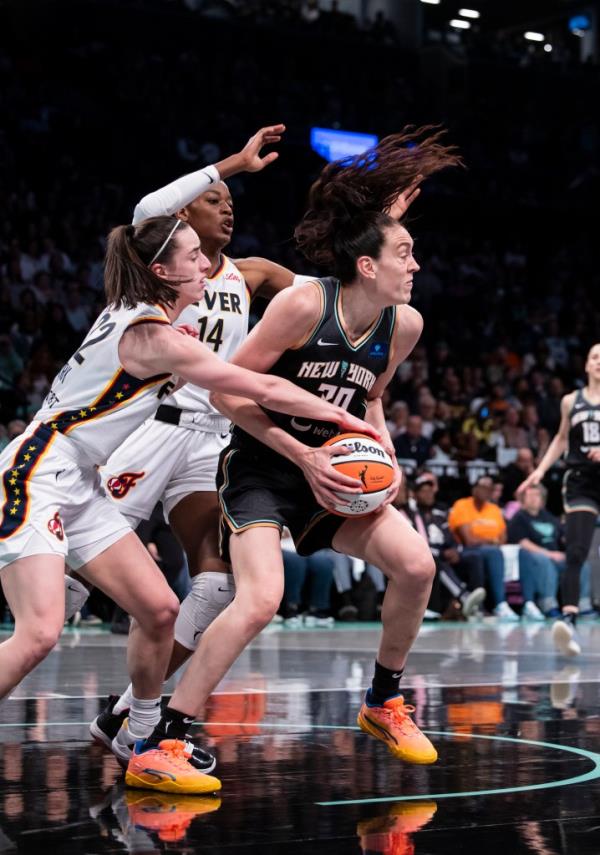 Breanna Stewart #30 of the New York Liberty defends against Caitlin Clark