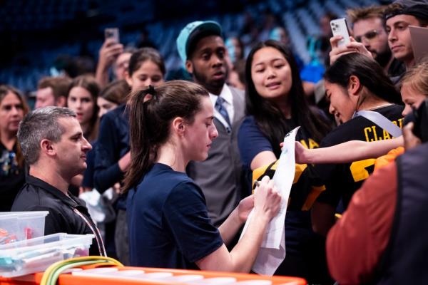 Caitlin Clark signs autographs prior to her game against the New York Liberty for their home opener at Barclays Center.