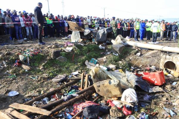 Residents gather at the scene of an accident wher<em></em>e a truck carrying a shipping co<em></em>ntainer veered off the road and plowed into several vehicles in Kericho county, Kenya on July 1, 2023. 