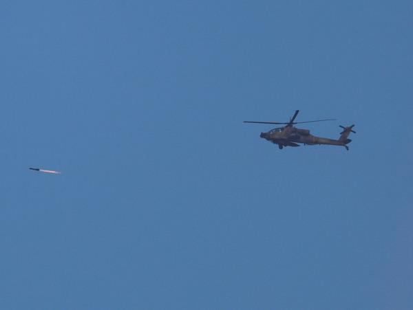 Israeli military's Apache helicopter fires a rocket as it flies over Gaza, as seen from southern Israel, amid the o<em></em>ngoing co<em></em>nflict between Israel and the Palestinian group Hamas, on Nov. 20, 2023. 