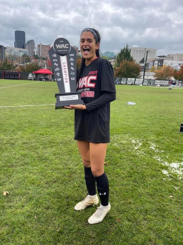 Thalia Chaverria with a soccer trophy.