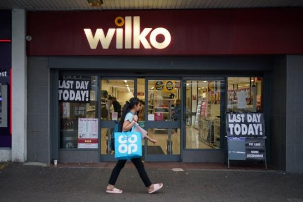 A person passes the Wilko store in Barking, east London, on the final day of its trading and one of the first set of Wilko stores to close down as the dramatic collapse of the high street chain takes shape. The historic retailer will shut 24 stores across the UK in the first phase of closures, with hundreds of workers at the shops set for redundancy. Picture date: Tuesday September 12, 2023. PA Photo. See PA story CITY Wilko. Photo credit should read: Yui Mok/PA Wire