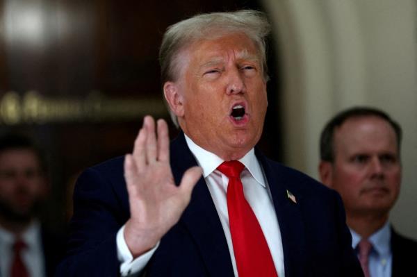 Do<em></em>nald Trump gestures while talking to the media during a break as he attends trial in a civil fraud case brought by state Attorney General Letitia James against him, his adult sons, the Trump Organization and others in New York City.