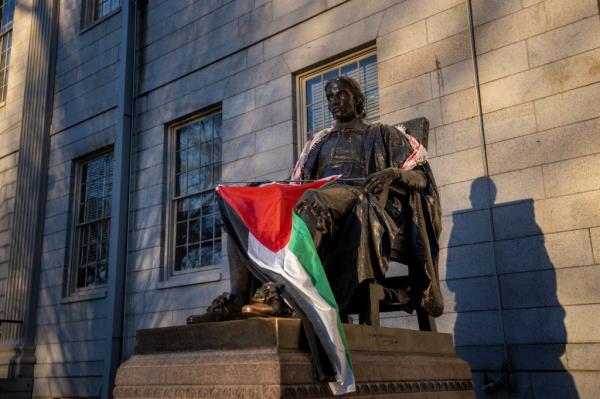 Harvard students draped the statue of John Harvard, the first major benefactor of Harvard College, in Palestinian garb.