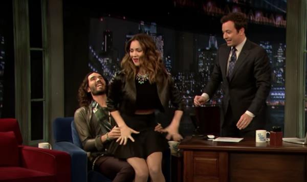 Russell Brand bounces Katharine McPhee on his lap during 