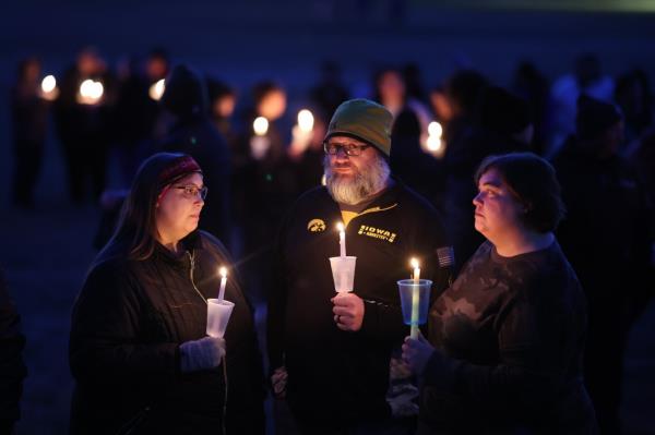 Community members gather in Wiese park for a candlelight vigil at the Perry Middle School and High School complex.