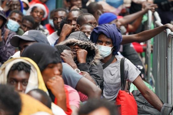 Asylum seekers waiting this afternoon to get into the Roosevelt Hotel.  