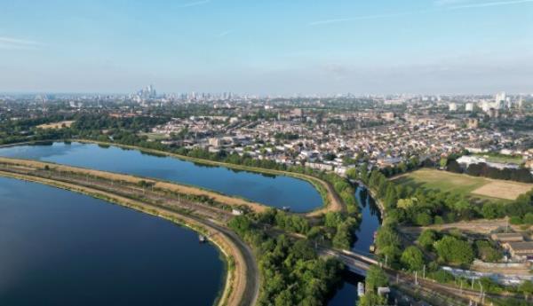 Aerial view of Walthamstow Reservoirs with The City of Lo<em></em>ndon and Canary Wharf visible on the horizon