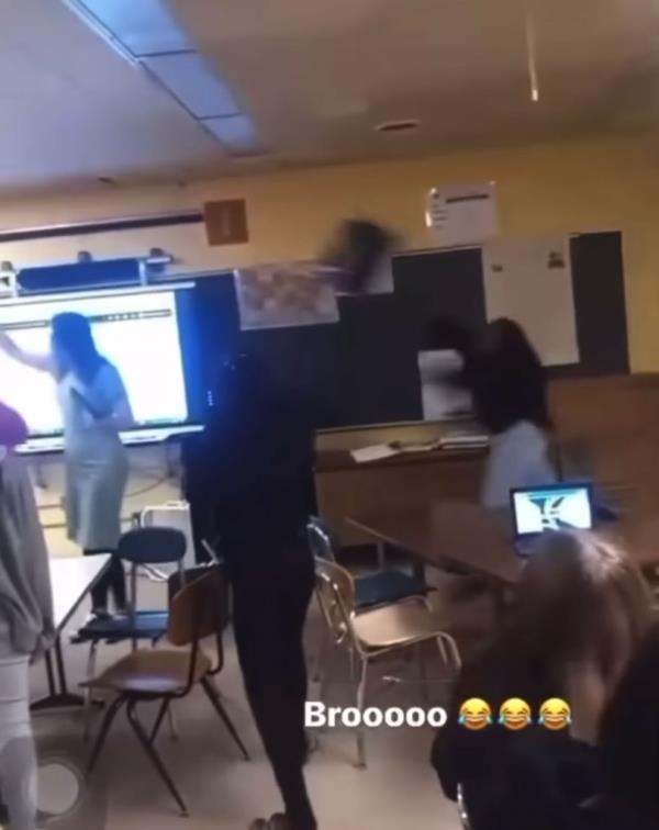 The 15-year-old student can be seen tossing the chair toward her teacher's head as she had her back turned.