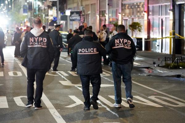 Police at the scene wher<em></em>e two people were shot - one in critical co<em></em>ndition - at 350 W37th Street in New York, NY around 12:15 a.m. on May 5, 2022. 