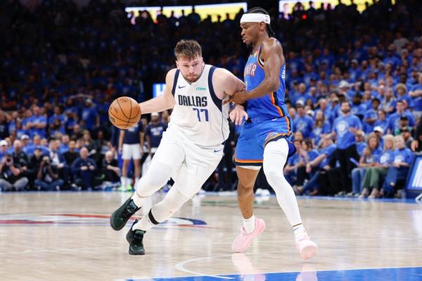 Luca Doncic, who scored 29 points, drives on Shai Gilgeous-Alexander during the Mavericks' 119-110 Game 2 win over the Thunder.