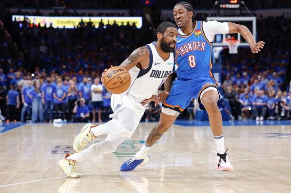 Kyrie Irving, who scored nine points and added 11 assists, drives past Jalen Williams during the Mavericks' win over the Thunder.