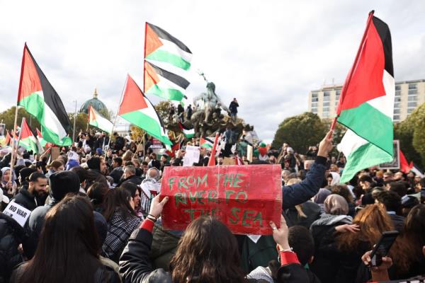 A protester holding a 'From the river to the sea' placard during a solidarity protest for Palestinians in Berlin, Germany.