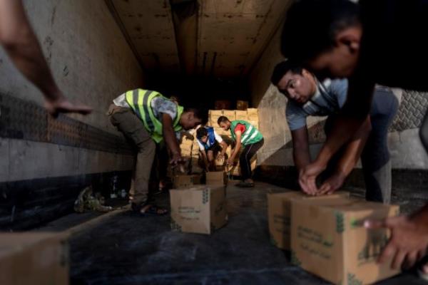 NORTH SINAI, EGYPT - OCTOBER 16: Volunteers load food and supplies o<em></em>nto trucks in an aid co<em></em>nvoy for Gaza on October 16, 2023 in North Sinai, Egypt. The aid convoy, organized by a group of Egyptian NGOs, set off today from Cairo for the Gaza-Egypt border crossing at Rafah. On October 7th, the Palestinian militant group Hamas launched a surprise attack on border communities in southern Israel, spurring the most violent flare-up of the Israel-Palestine co<em></em>nflict in decades. Israel launched a vast bombing campaign in retaliation and has warned of an imminent ground invasion. (Photo by Mahmoud Khaled/Getty Images)