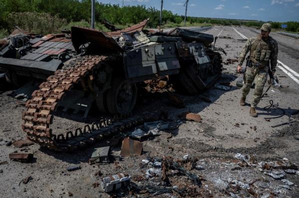 A Ukrainian serviceman walks near a destroyed Ukrainian tank, as Russia's attack on Ukraine continues, near the village of Robotyne, Zaporizhzhia region, Ukraine August 25, 2023. 