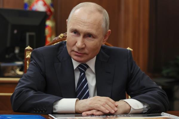 Russian President Vladimir Putin listens to Omsk Region Acting Governor Vitaly Khotsenko during a meeting at the Kremlin in Moscow, Russia, Monday, Aug. 28, 2023. 