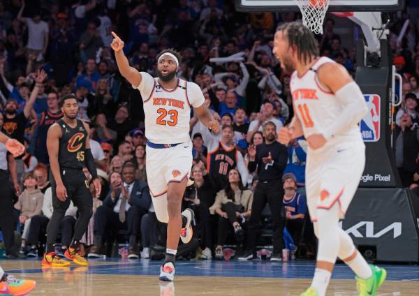 Knicks center Mitchell Robinson #23 reacts after he slams the ball over Cleveland Cavaliers center Jarrett Allen