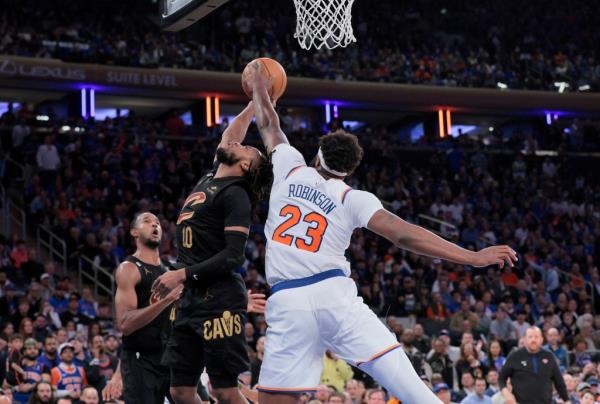 Knicks center Mitchell Robinson #23 blocks Cleveland Cavaliers guard Darius Garland