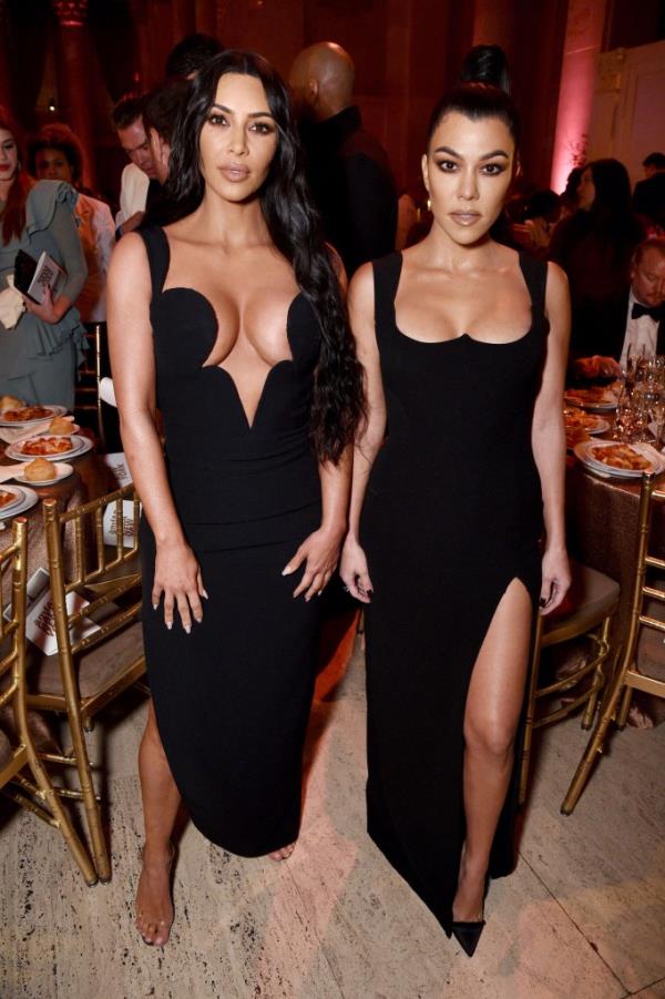 Kourtney and Kim Kardashian in long black dresses. 