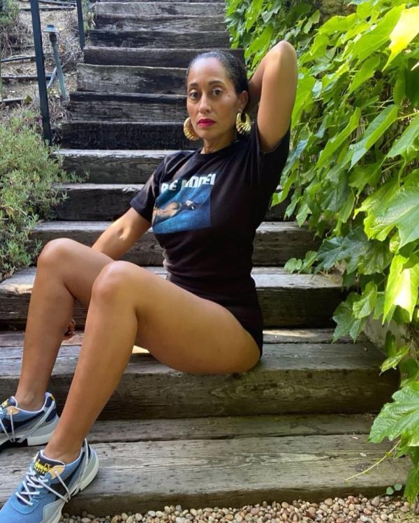 Tracee Ellis Ross sitting on stairs in sporty attire after receiving a gift from the Duchess