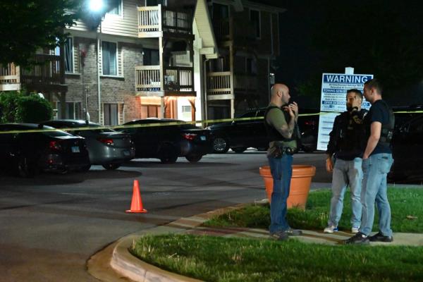 Glendale Heights apartments with cops standing out in front and yellow crossing tapes.