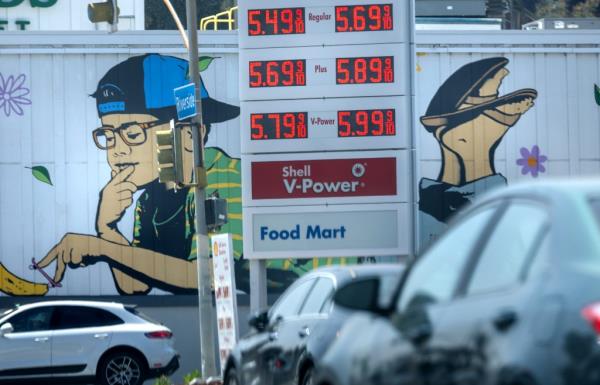 Gas station sign displaying rising prices in Sherman Oaks, Los Angeles, amid Memorial Weekend with 2.9 million people driving to getaways.