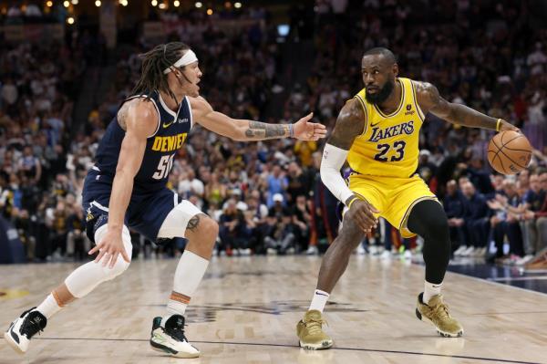 Aaron Gordon #50 of the Denver Nuggets guards LeBron James #23 of the Los Angeles Lakers in the third quarter during game five of the Western Co<em></em>nference First Round Playoffs at Ball Arena on April 29, 2024 in Denver, Colorado.  