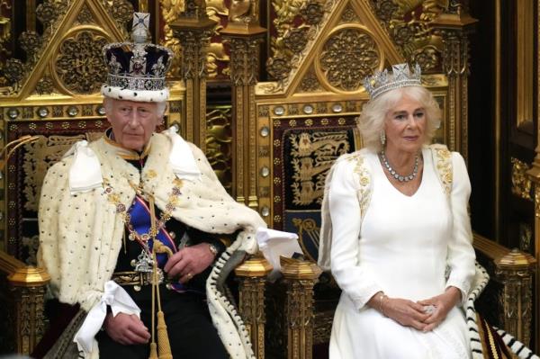 King Charles III wearing the Imperial State Crown and Robe of State, alo<em></em>ngside Queen Camilla at the State Opening of Parliament 2024 in London, England