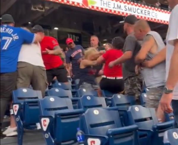 A group of people at a ba<em></em>seball stadium in downtown Cleveland for a Friday night event.