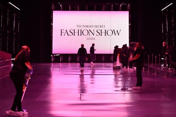 People prepare the runway prior to the Victoria's Secret Fashion Show on Tuesday, Oct. 15, 2024.