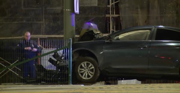 Wrecked car seen at intersection of Crenshaw Boulevard and 52nd Street in Los Angeles Sunday