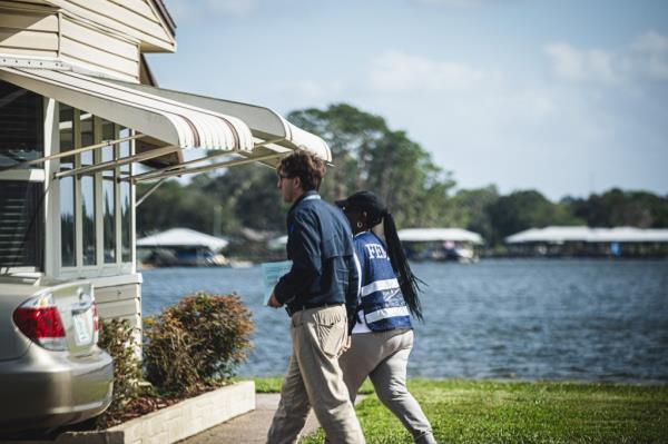 FEMA employess walk through the Tropical Harbor Estates mobile home park which was affected by tornados that were spun off of Hurricane Milton.