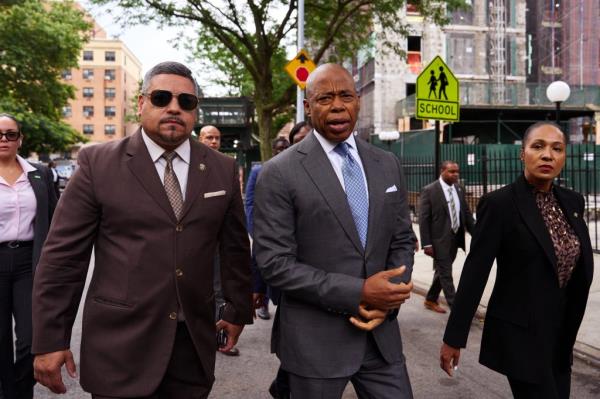 Caban and Adams walk the street.