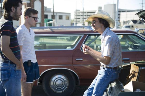 Matthew McCo<em></em>naughey in cowboy hat portraying Ron Woodroof in Dallas Buyers Club, discussing with another man