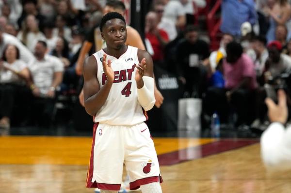 Miami Heat guard Victor Oladipo applauds during a basketball playoff game against the Milwaukee Bucks.