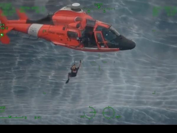 Coast Guard rescues man and his two children clinging to a capsized boat in the Pacific Ocean off Hawaii.