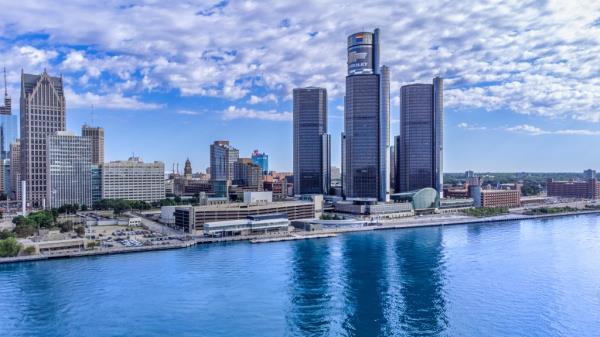 The Renaissance Center (complex of skyscrapers with the Chrevrolet sign) in city urban skyline by the Detroit River