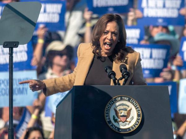 Vice President Kamala Harris speaking at a podium at Throwback Brewery in North Hampton on September 4, 2024